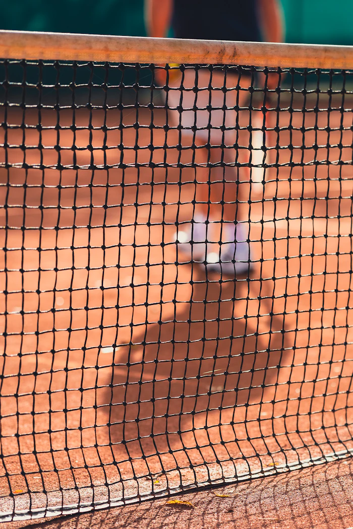 Tennis player swinging at a ball. Stock photograph.
