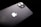 A black smartphone featuring a dual-lens camera and the iconic white apple logo. The device is slightly tilted against a dark background, highlighting its sleek and glossy finish.