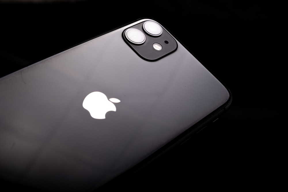 a close up of an iphone with a black background