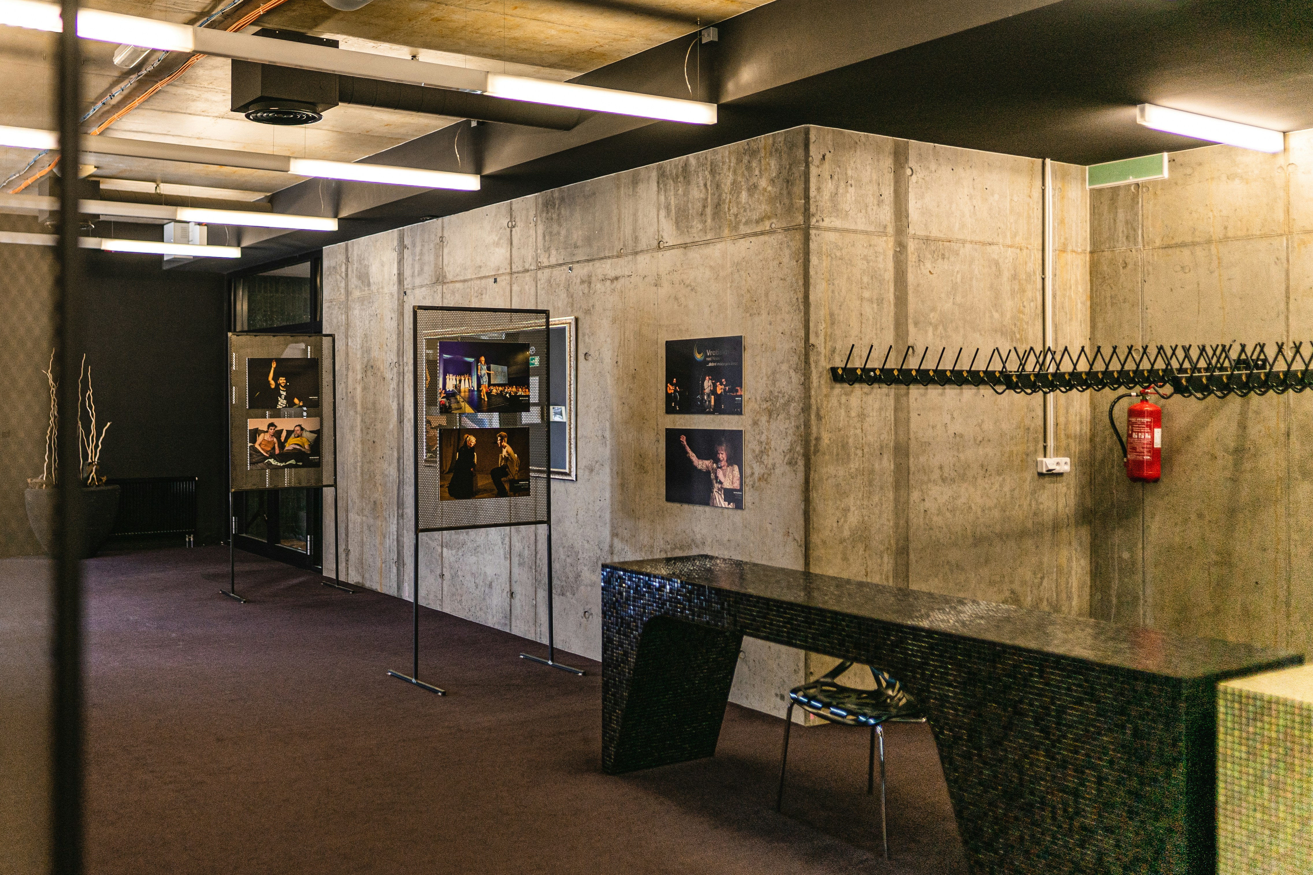 Room with bench and pictures on wall