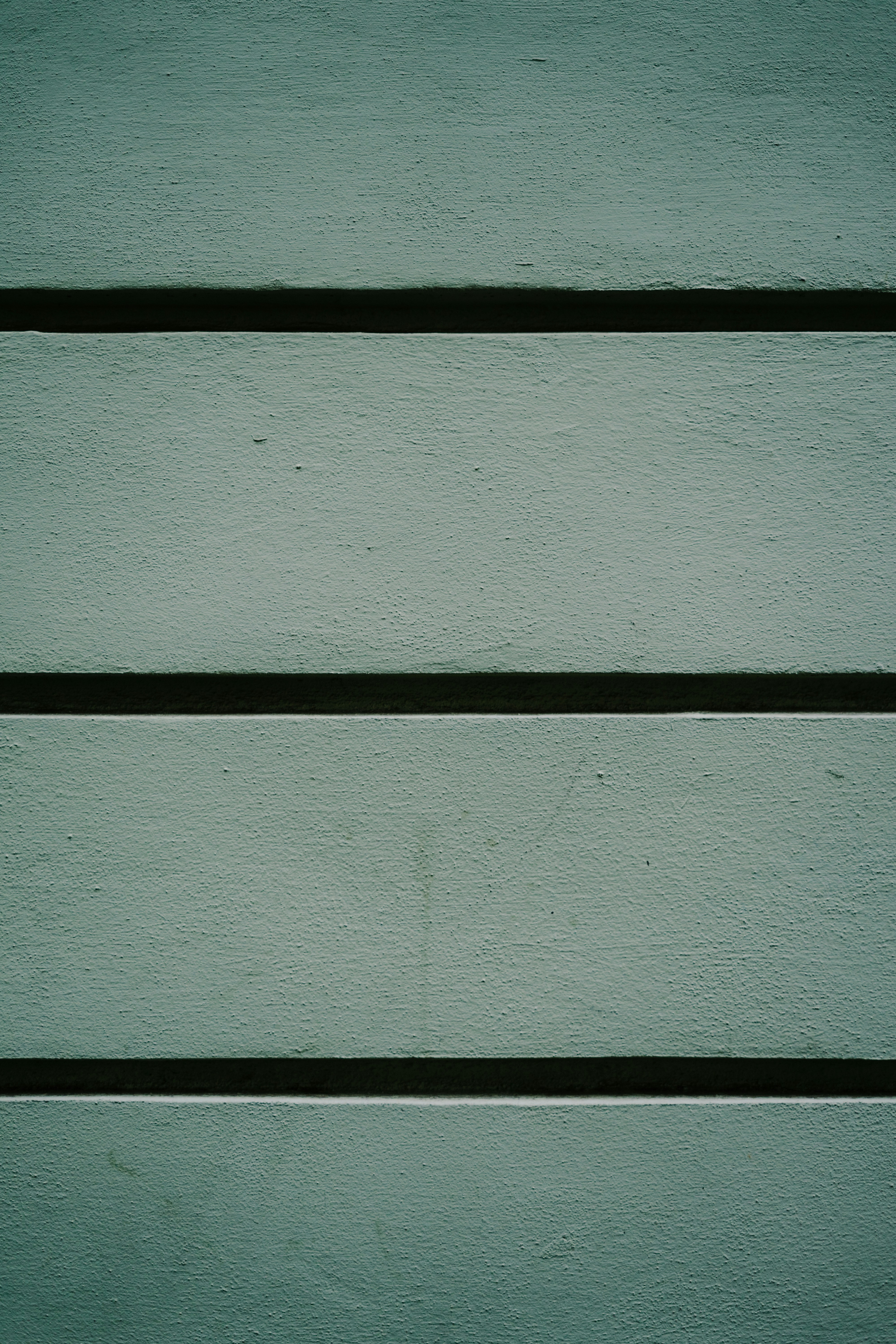 a close up of a green painted wall