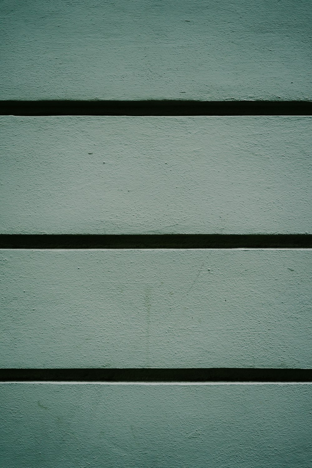 a close up of a green painted wall