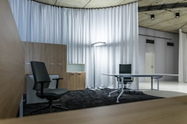 A sleek modern office space with black, white, and gold accents reflecting a professional digital agency.