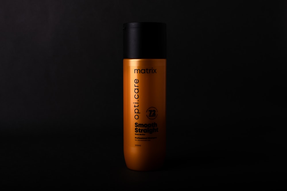 a bottle of shampoo on a black background