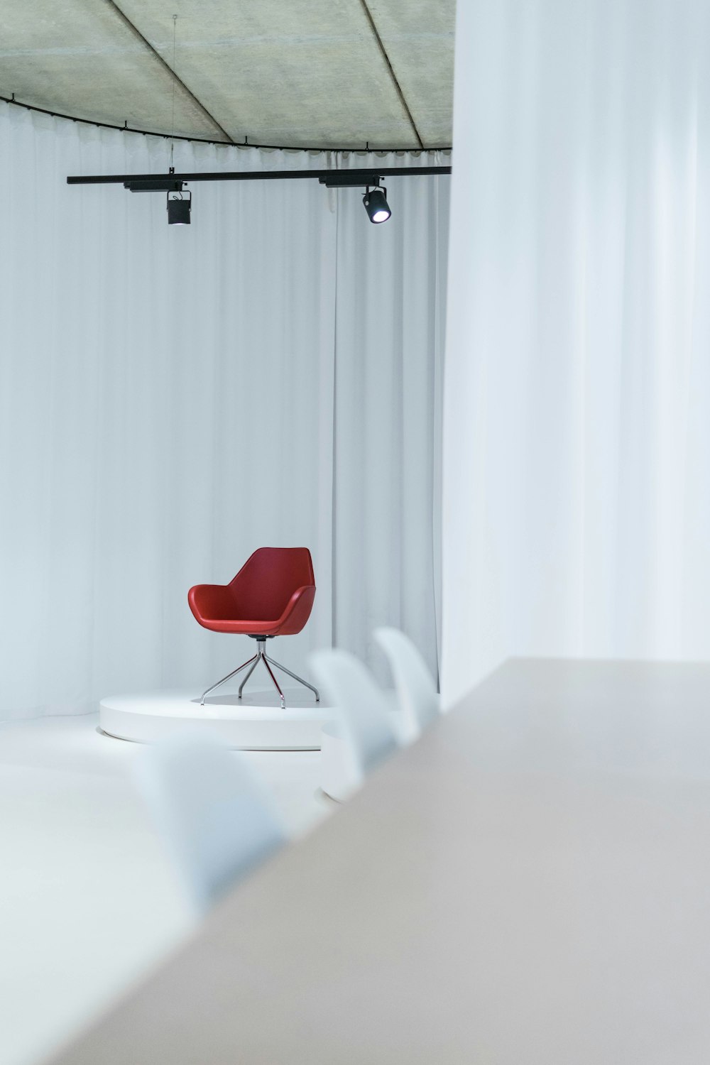 a red chair sitting on top of a white table