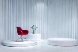 A minimalist living room scene with slippers casually placed near a comfy chair.