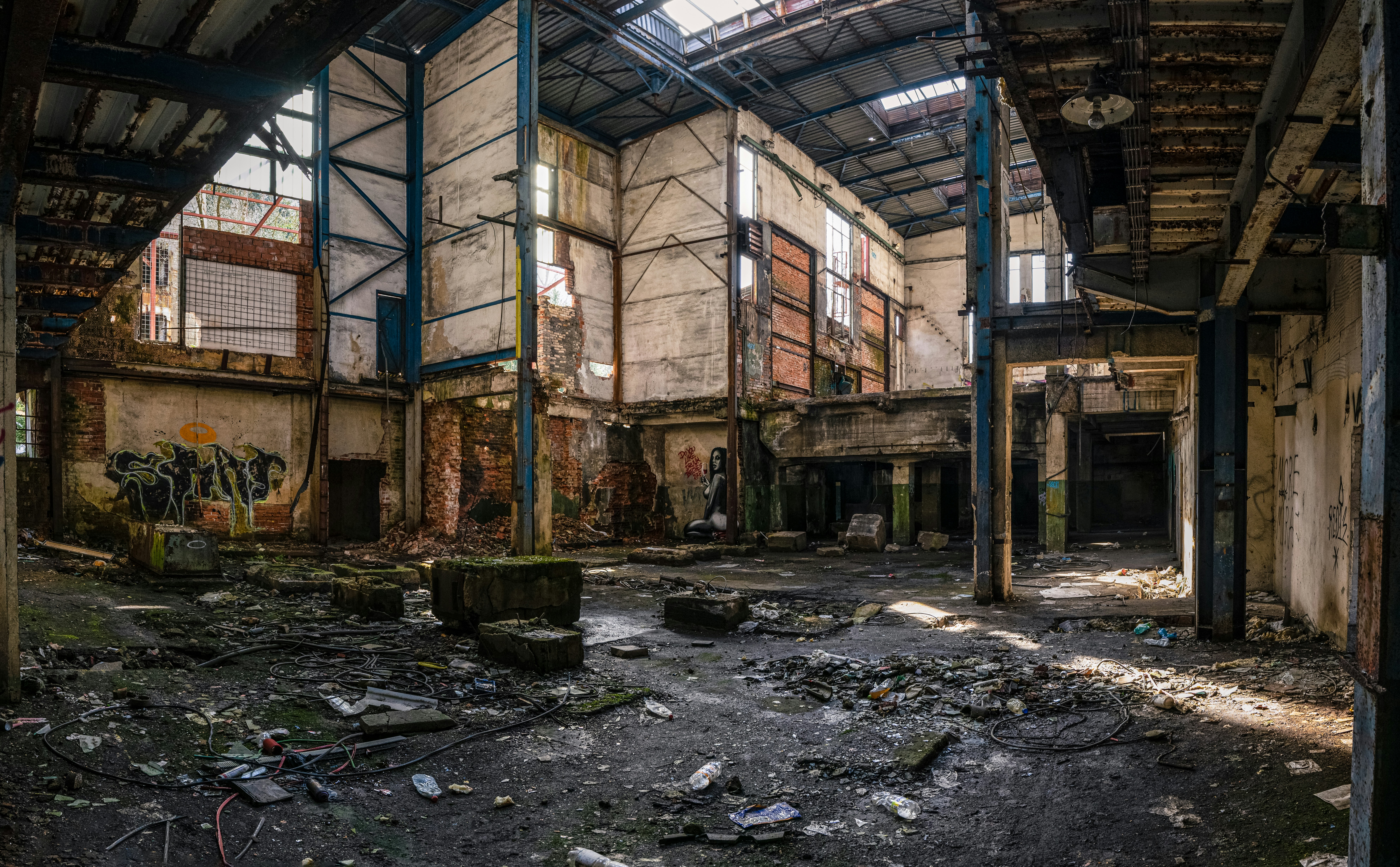 an abandoned building with lots of windows and debris
