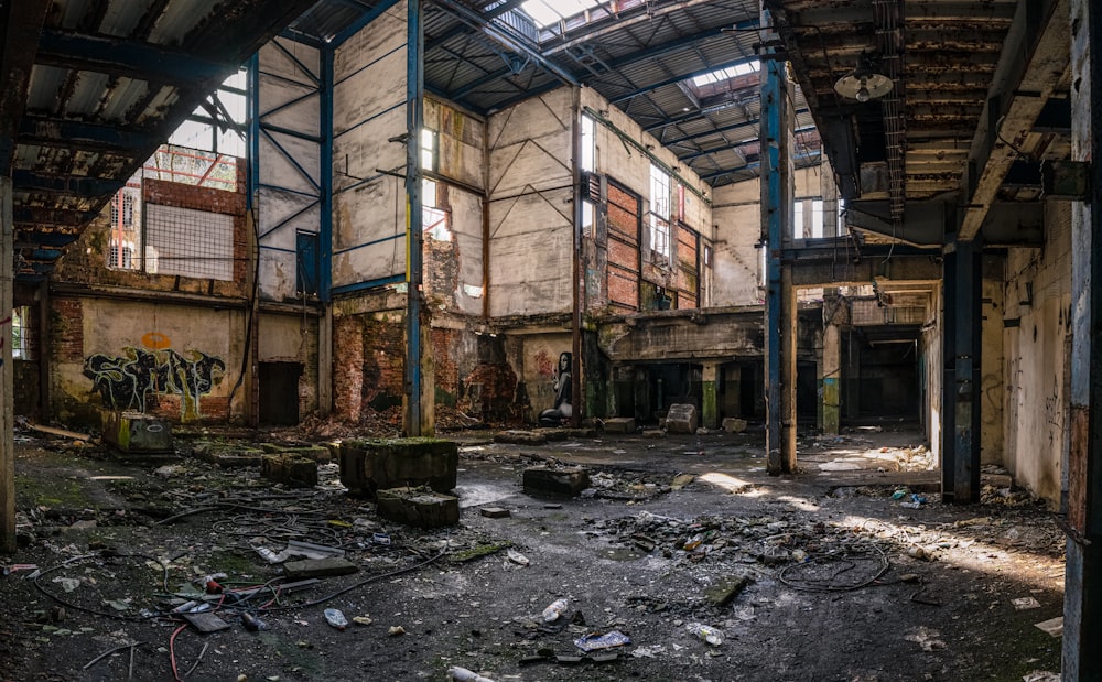 an abandoned building with lots of windows and debris