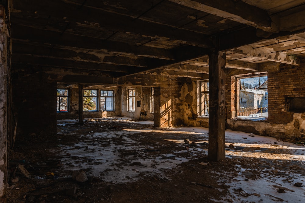 an abandoned building with snow on the ground