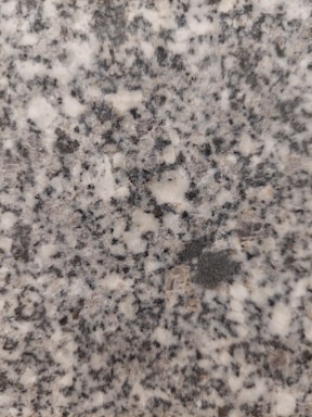 Close-up of a polished granite slab reflecting light in a workshop.