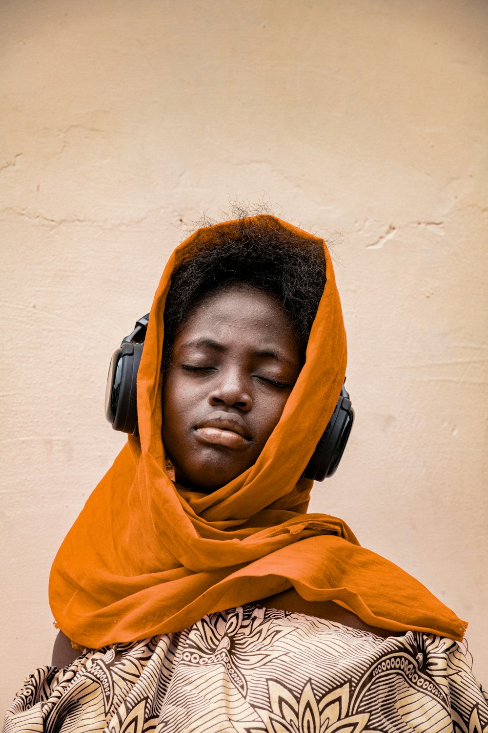 a person wearing headphones and a scarf