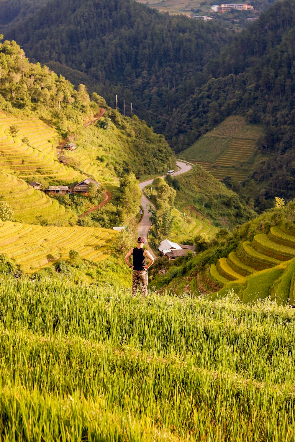 a person standing on a hill overlooking a valley