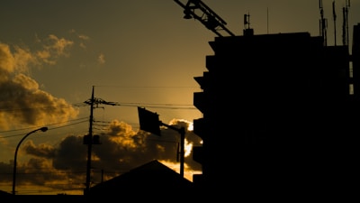 Lightning rod installation on top of a commercial building at sunset.