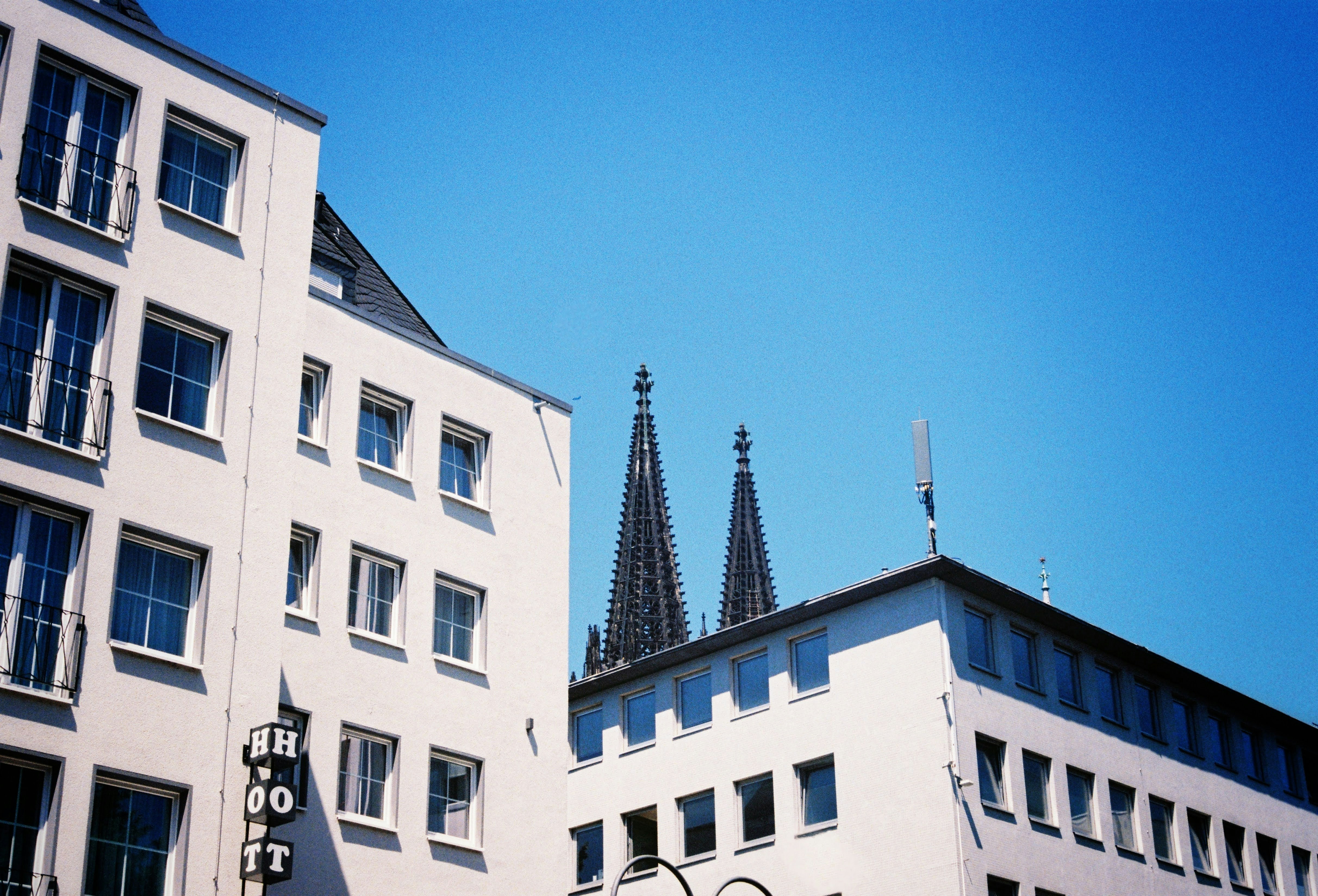 a tall white building with a clock on it's side