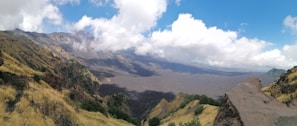 A panoramic view of the lush green slopes and volcanic landscape of Mount Rinjani.