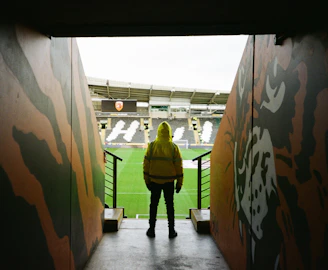 a person in a yellow jacket standing in a tunnel