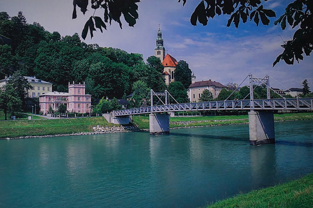 a bridge over a river with a building in the background