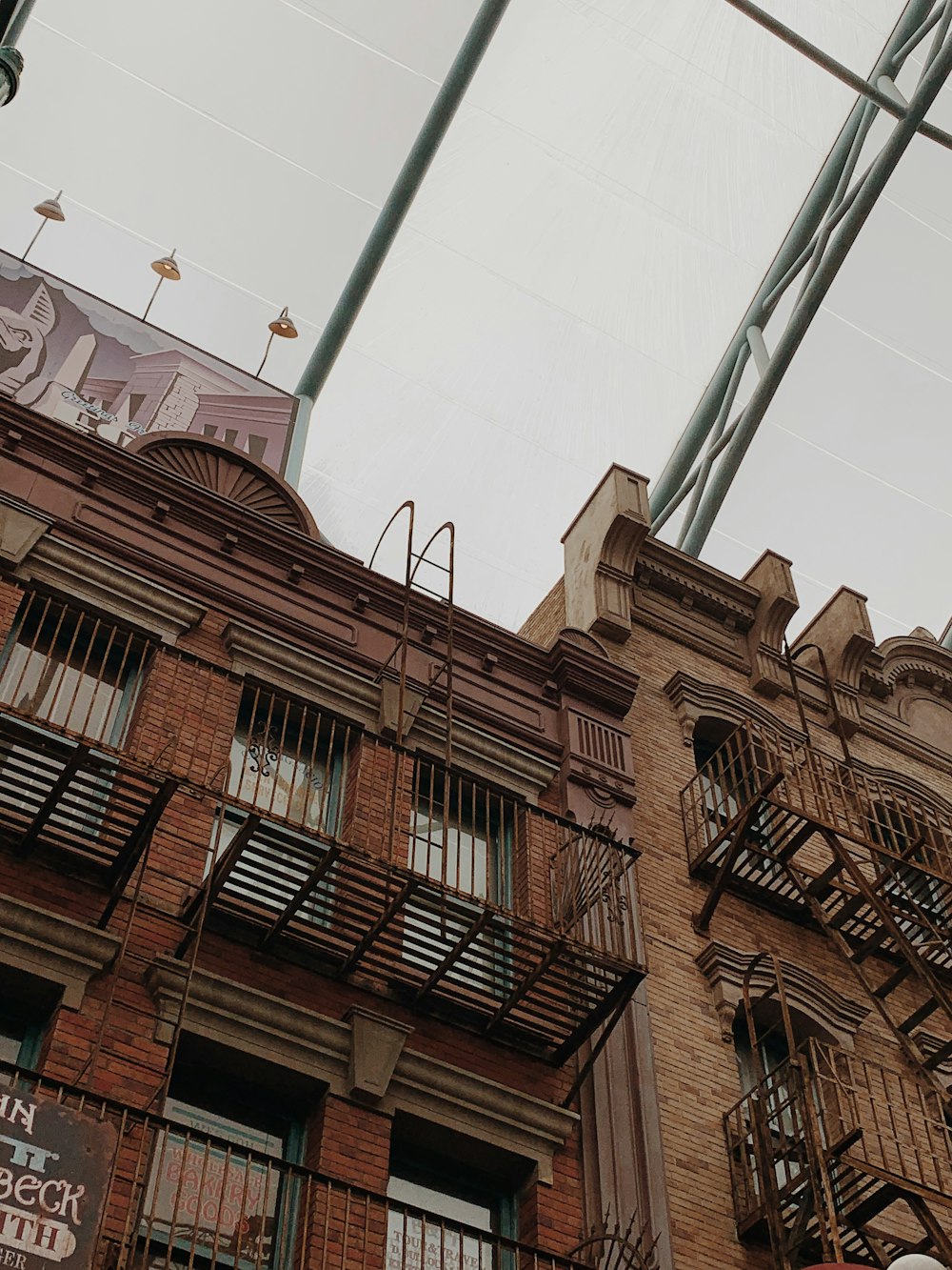 a tall brick building with lots of windows and balconies