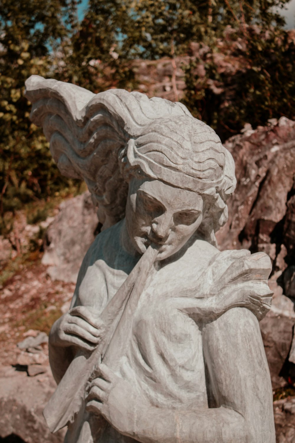 a statue of an angel holding a flute