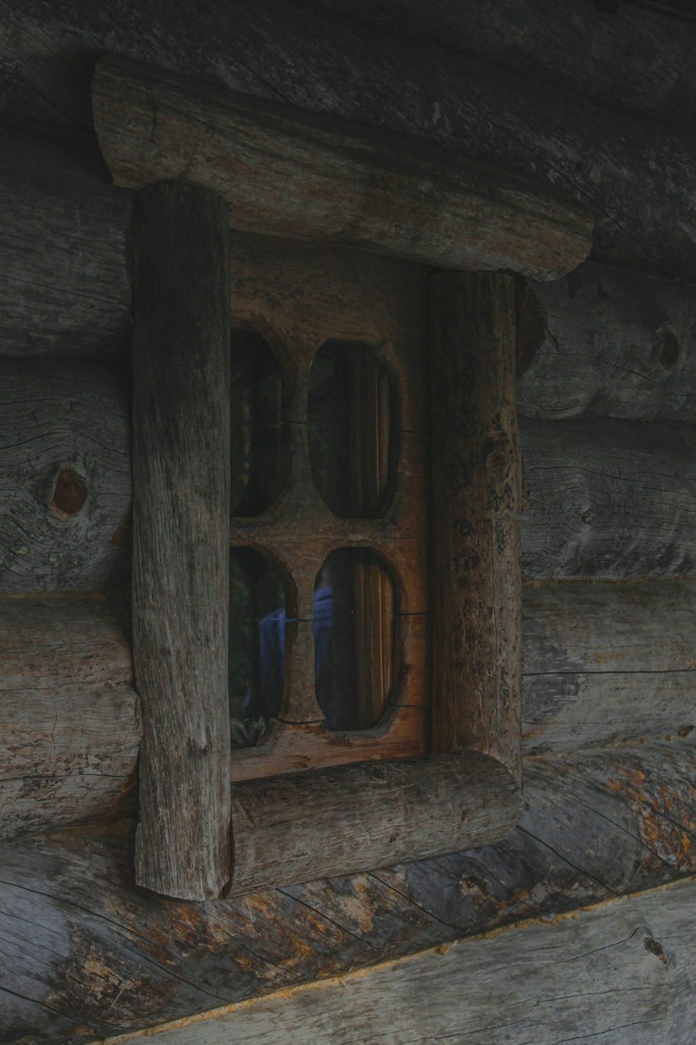 a close up of a window in a log cabin