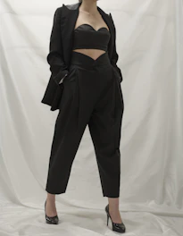 Casual chic outfit featuring a white blouse paired with tailored black trousers.