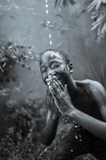 Close-up of a joyful child playing in the rain in a small village.