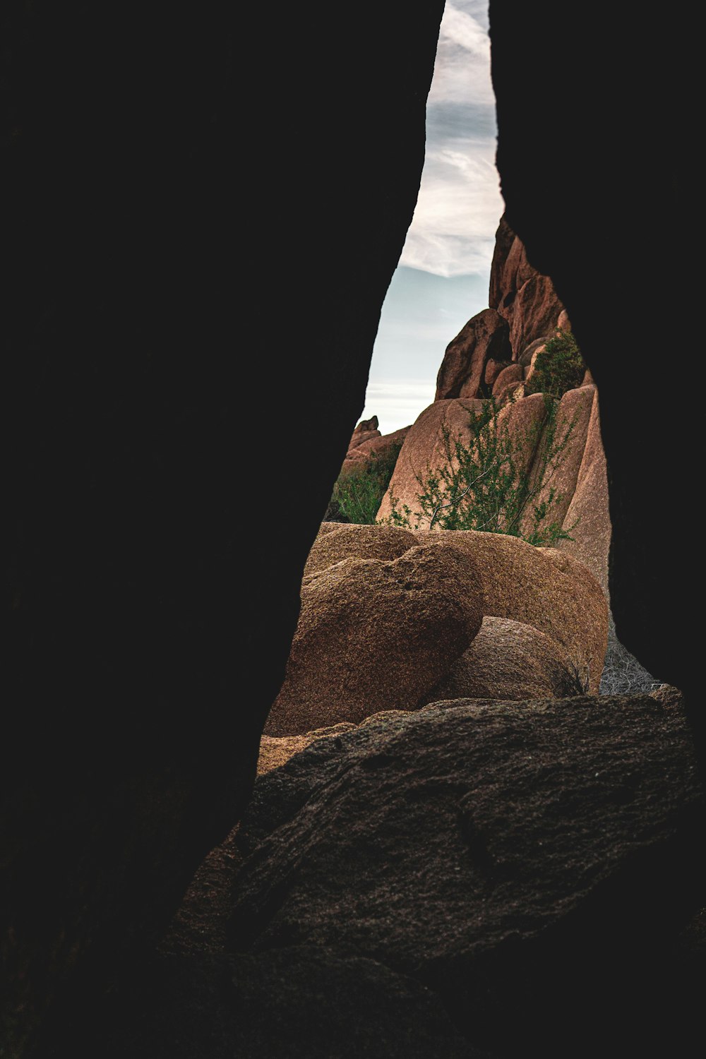 a view of a mountain through a cave