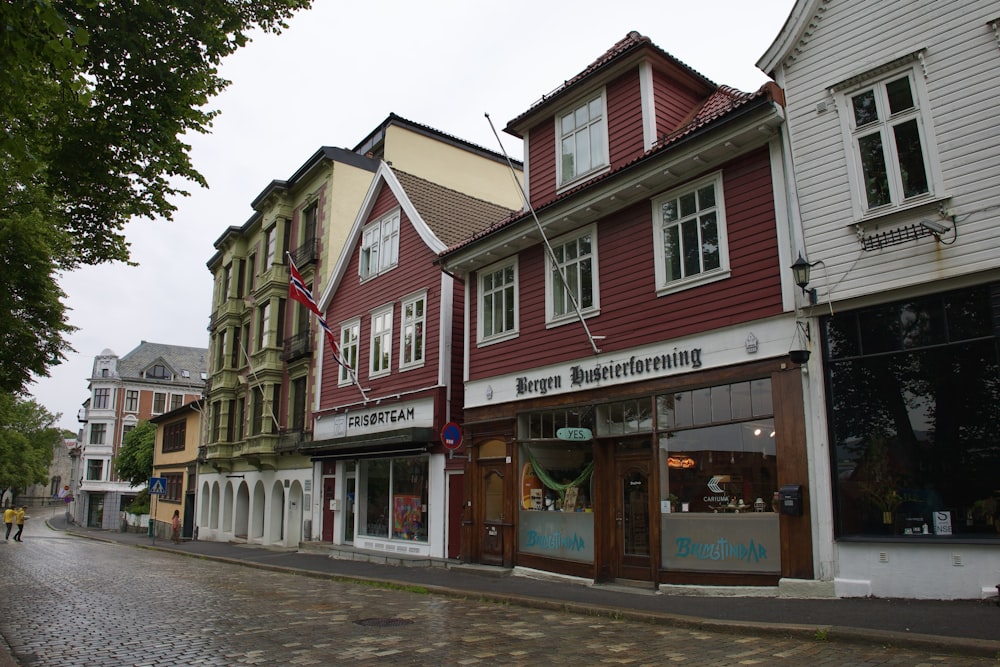 a row of buildings on a cobblestone street