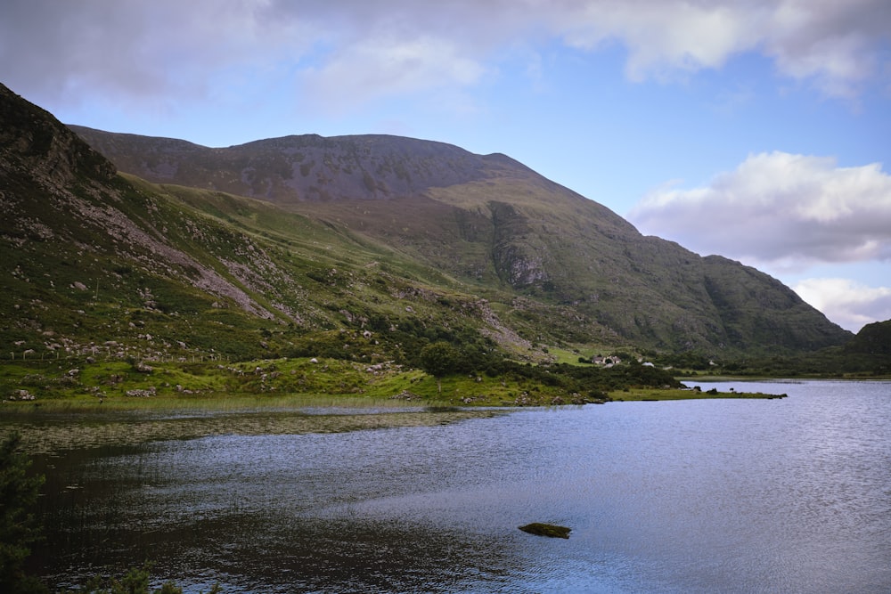 a body of water with mountains in the background