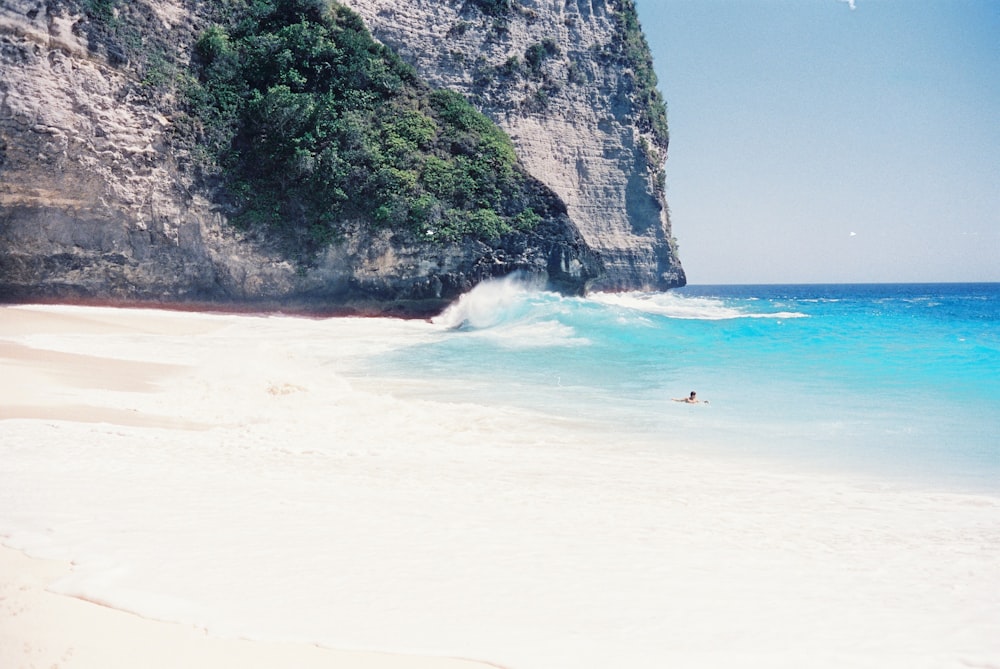 a person riding a surfboard on a wave in the ocean