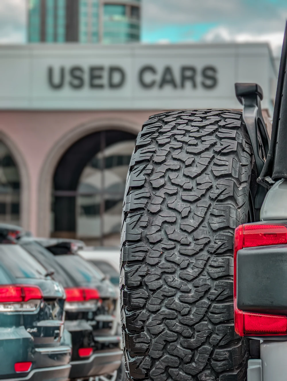 Vehicles lined up at a used car dealership, photographed by Koons Automotive