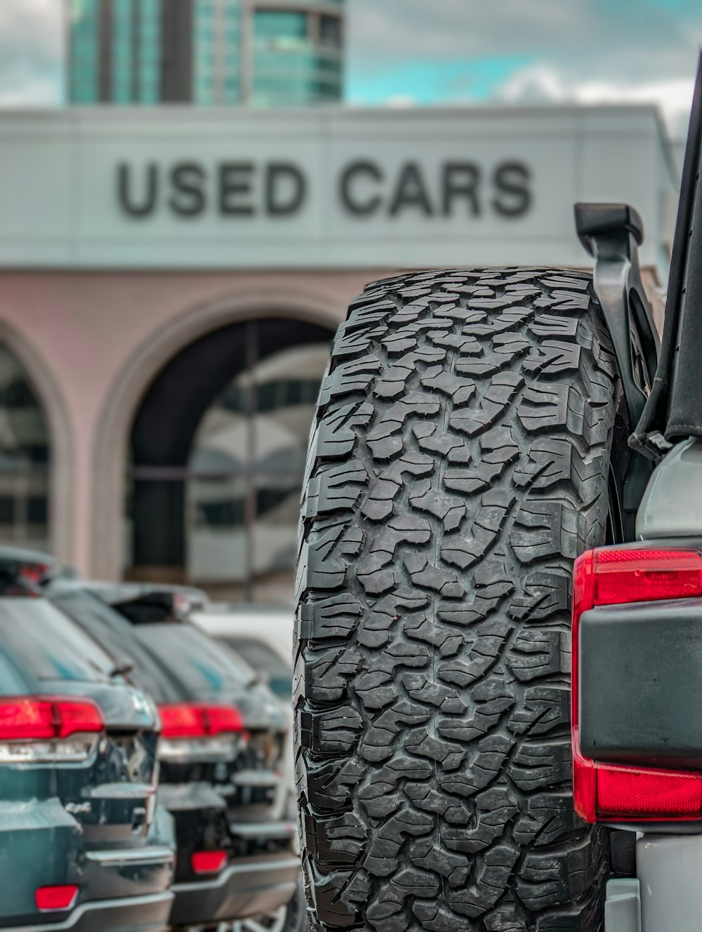 a row of cars parked in front of a used car dealership