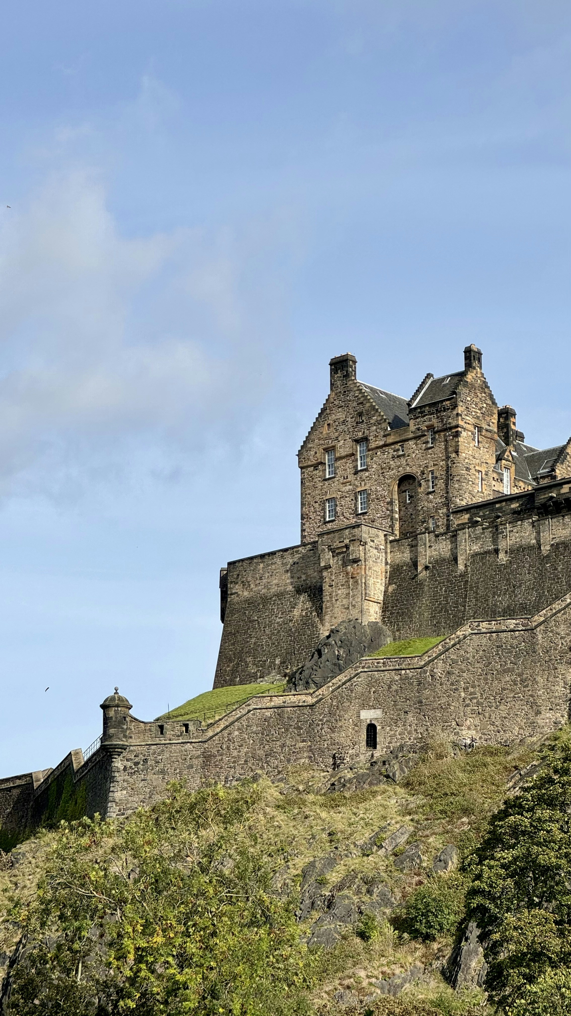 a castle on top of a hill with a sky background
