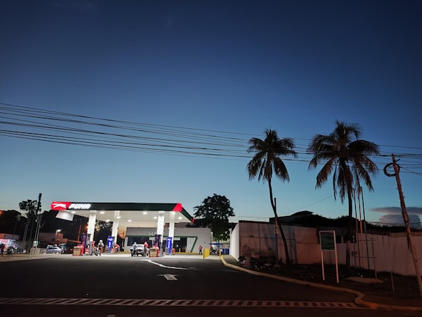 Evening shot of a pop-e station glowing softly under festival lights, with people waiting patiently.