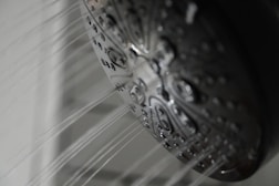 a close up of a shower head in a bathroom