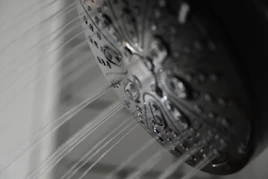 a close up of a shower head in a bathroom