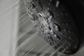 a close up of a shower head in a bathroom