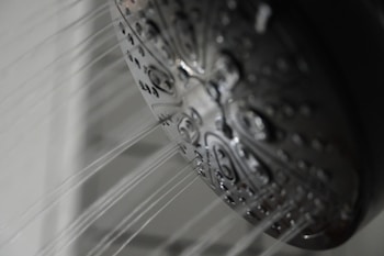a close up of a shower head in a bathroom