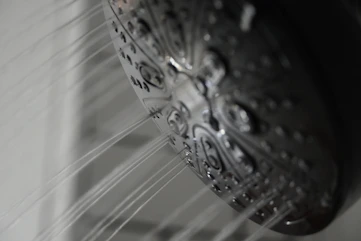 a close up of a shower head in a bathroom