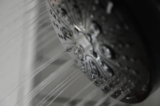 a close up of a shower head in a bathroom