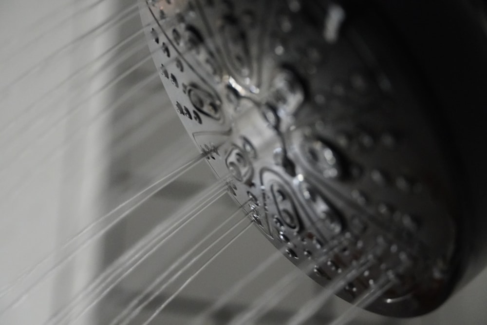 a close up of a shower head in a bathroom