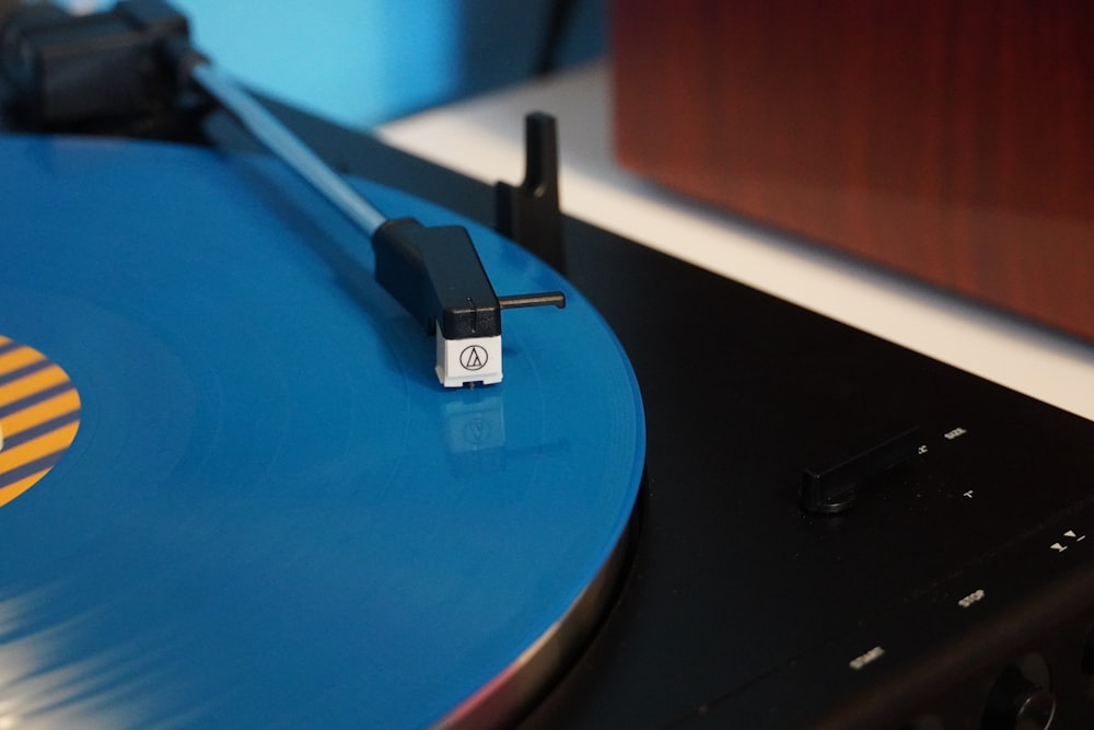 a record player with a blue record on top of it