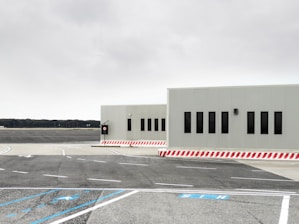 Construction site with workers installing durable ground markings under clear skies.
