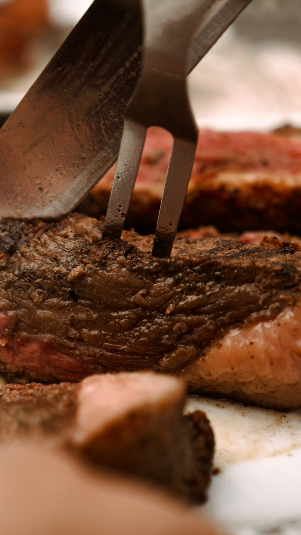 a steak being cut into pieces with a knife