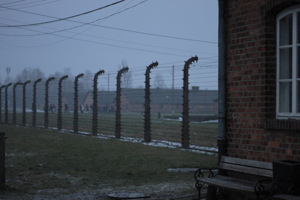 a row of barbed wire next to a brick building