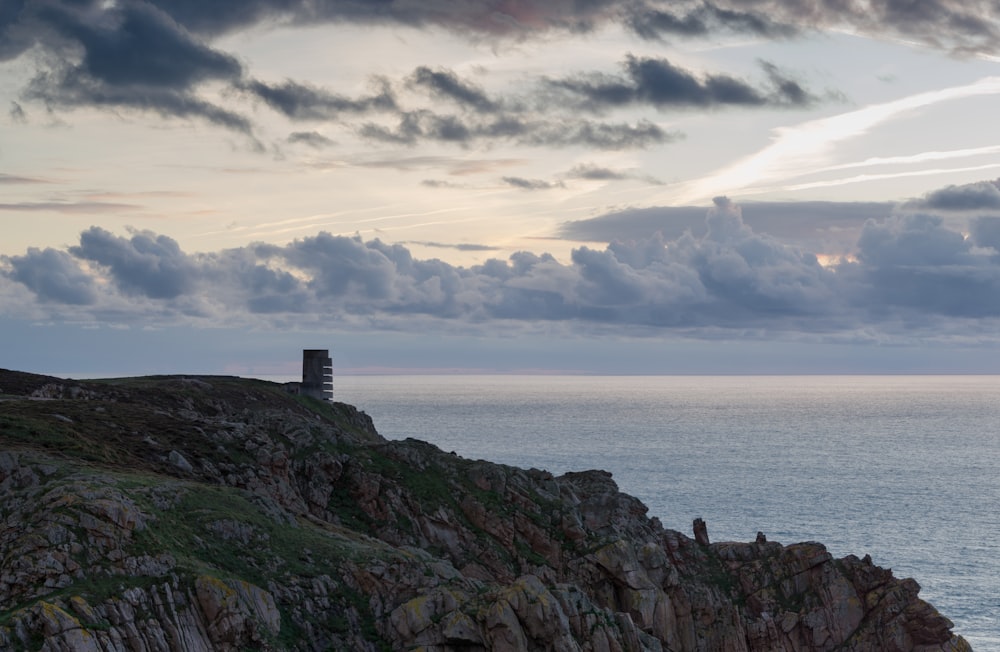 a lighthouse on a rocky outcropping overlooking the ocean