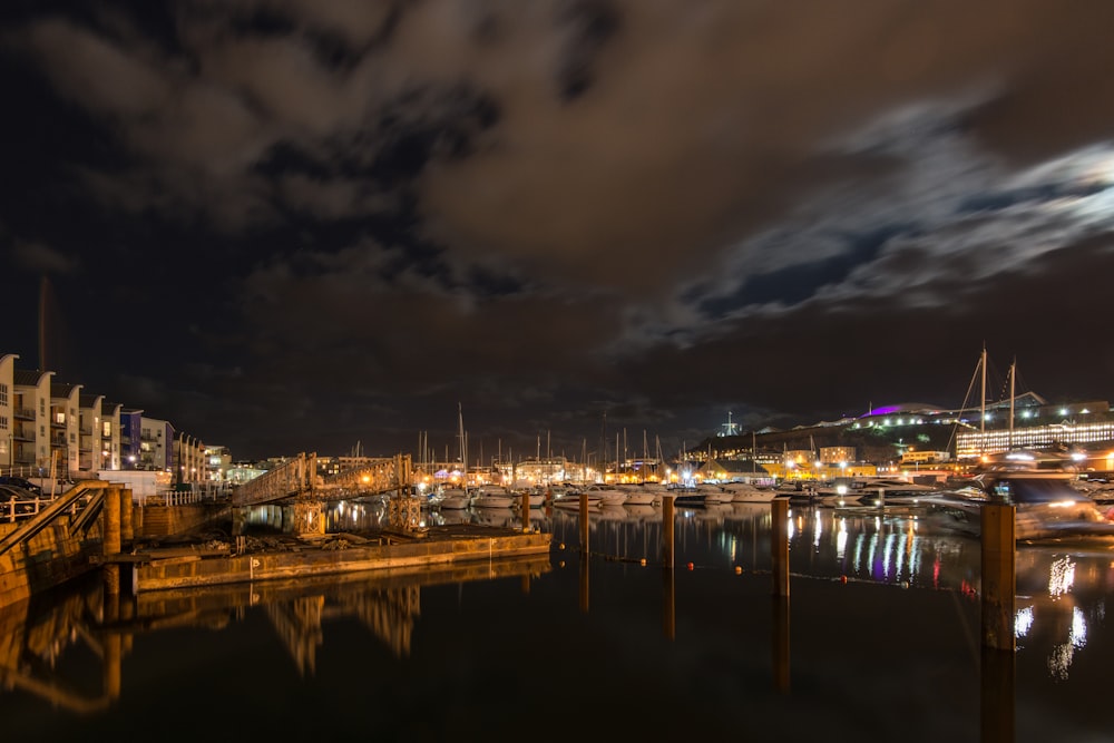 a harbor filled with lots of boats under a cloudy sky