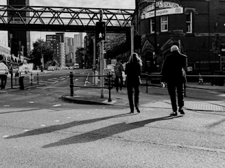 A thoughtful portrait of Dennis and Michael standing together in a Manchester street.