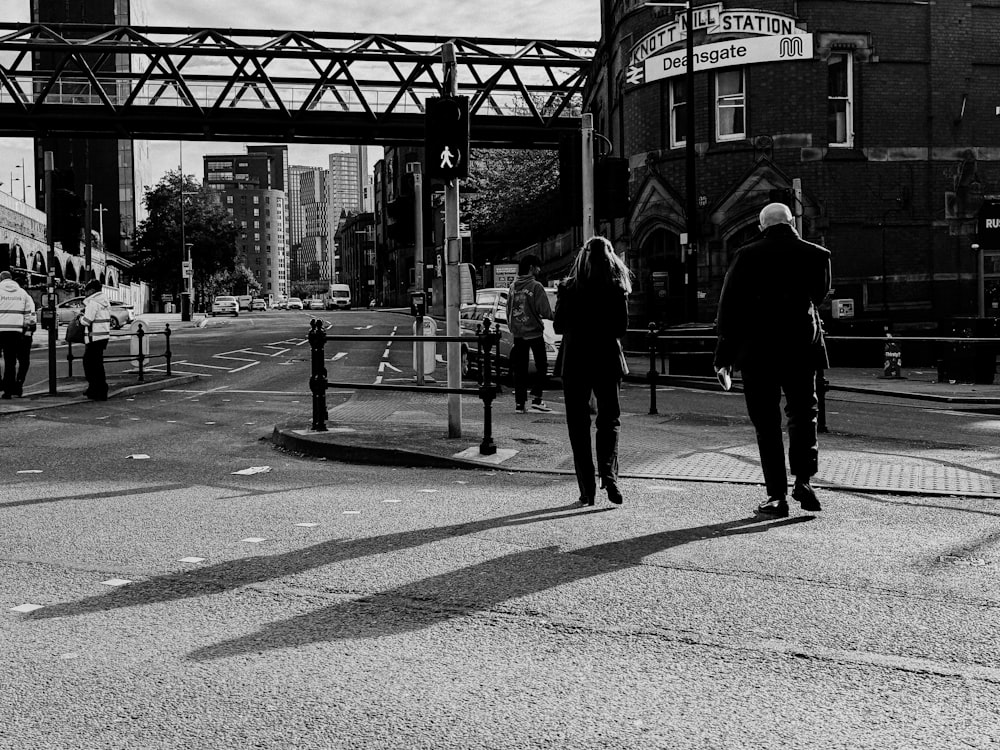 a couple of people walking across a street