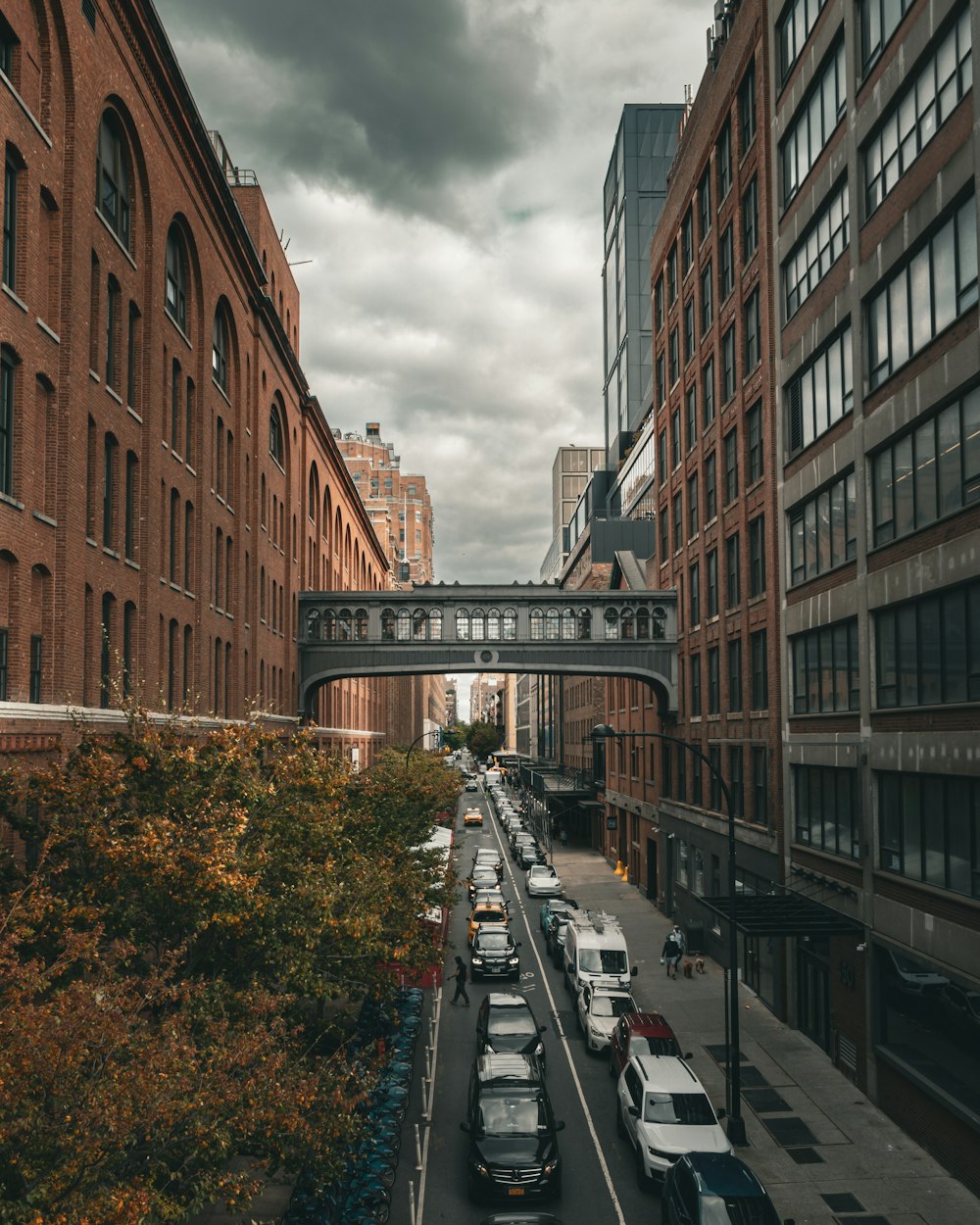 a city street filled with lots of traffic under a cloudy sky